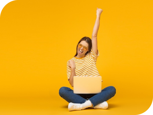 A person sitting on a laptop celebrating.